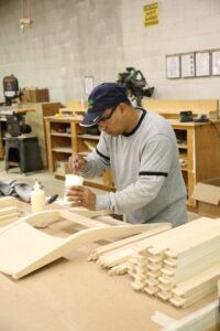 a man hand making furniture in the USA